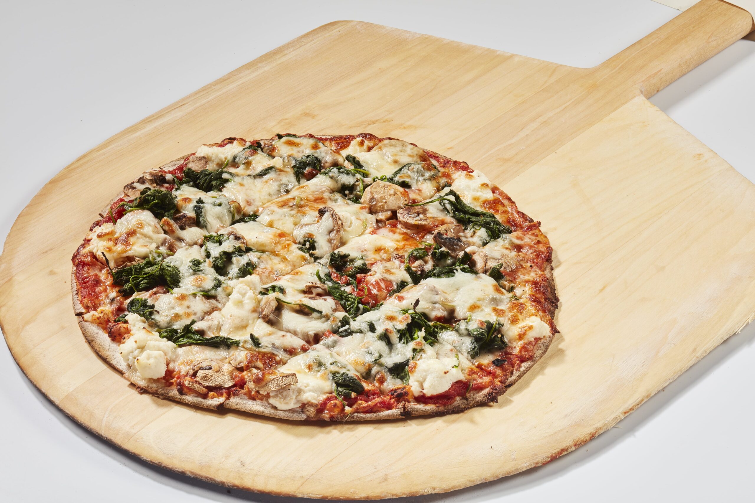 Thin Crust Spinach, Ricotta, nutmeg, and mushroom pizza.